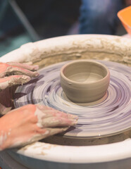 Fototapeta na wymiar Pottery lesson master class for kids children, process of making clay pot on pottery wheel, potter wet hands creating ceramic crockery handcrafts, ceramist molding jar or vase