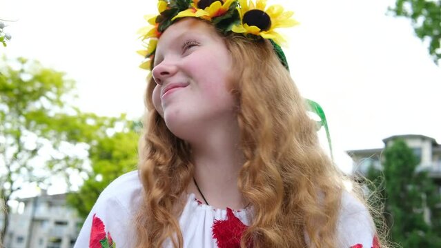 beautiful young women girls weaving wreaths walking laughing chatting in park in garden embroidered national ukrainian shirts wreaths of sunflower flowers and forest white flowers beautiful vyshyvanka