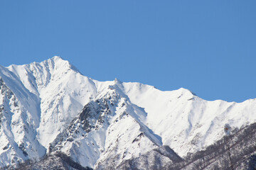 Snow-covered peaks in clear blue sky