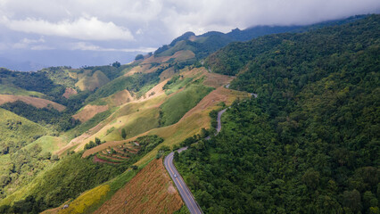 Shot from a drone camera angle at the Sky Road. Road 1256, Unseen Road, Nan Province, Thailand. It winds along the ridge of the forest. very beautiful view The rainy season will be green