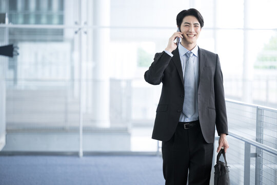 Businessman contacting by phone Images of airports and commuting business trips Photocopy space available