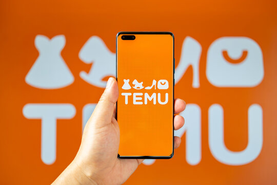 ZHONGSHAN China-June 15,2023:man holding a mobile with Temu logo at horizontal composition.