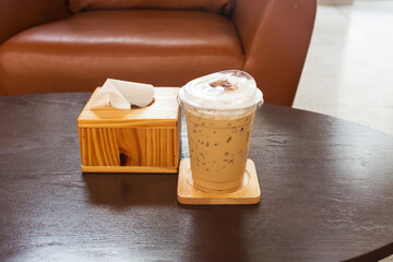 Ice coffee cup on woodden table,selected focus.