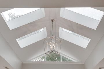 Minimal Bright Modern Skylight Vaulted Ceiling with Silver Metal Double Box Chandelier in Luxury Interior