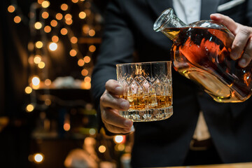 Barman pouring whiskey whiskey glass..