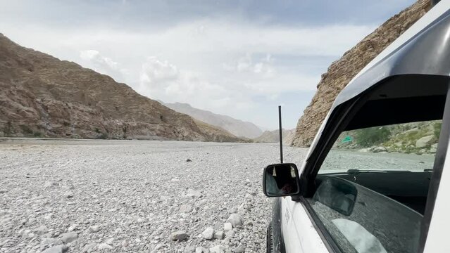POV Outside SUV Window Driving Along Desert Rock Landscape In Khuzdar,  Balochistan