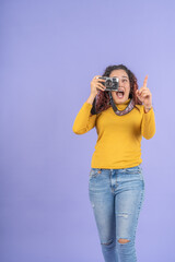 Excited young woman using an antique camera