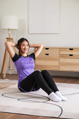 Asian woman in sports wear warm up before workout at home. home exercise concept.