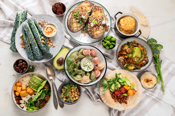 Vegetarian and various vegan dishes on light table. Healthy food concept with vitamins, fiber and antioxidants.