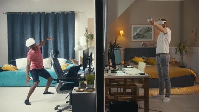 Multi ethnic men, neighbours in VR headsets play extended reality video games using wireless controllers in different rooms or apartments separated by wall. Concept of neighbourhood and lifestyle.