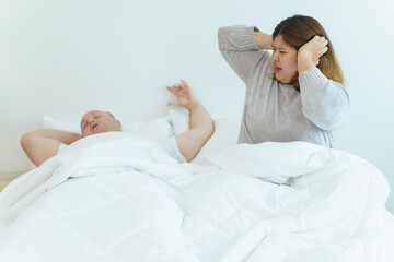 Obraz na płótnie Canvas Wife angry her husband about snoring loudly when sleeping.