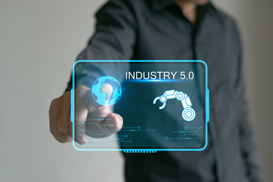 INDUSTRY 5.0 Industrial engineers in factories work with robotic arm machines in smart factories in real-time monitoring system software. Digital future manufacturing