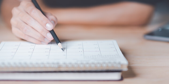 Strategic Planning Concepts, brainstorm ideas on business plans, Updating schedules or planning business, teamwork and data analysis, marketing development, This male hand at the calendar to schedule