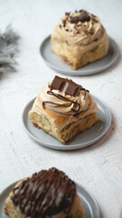 Delicious sweet cinnamon roll with some chocolate over in a white background