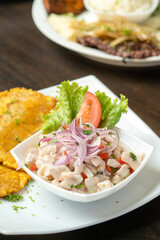 Amazing fish ceviche with fried plantains and some salad made in latin america 