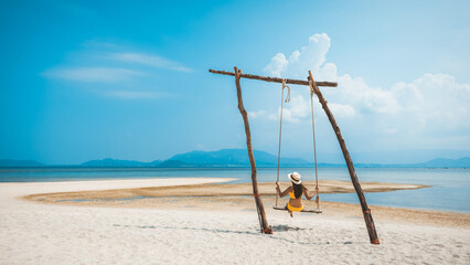 Traveler asian woman relax and travel in swing on summer beach at Koh Rap Samui in Surat Thani Thailand - 613403567