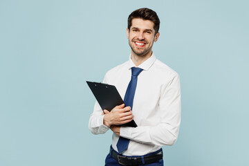 Young fun employee IT business man corporate lawyer wear classic formal shirt tie work in office hold clipboard with paper account documents isolated on plain pastel blue background studio portrait.