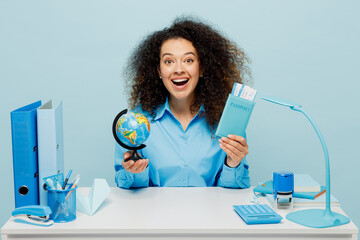 Traveler employee business woman wear shirt sit work at office hold passport ticket globe isolated...