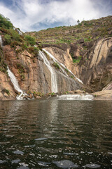 Fototapeta na wymiar water from mountain waterfalls reaching the river