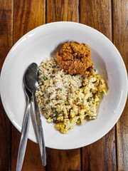 Fried rice with fried chicken on white plate. Top view delicious food.
