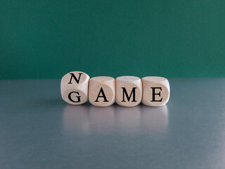 Name of the game symbol. Wooden cubes with concept words Name Game. . Beautiful grey table green background. Business and name of the game concept. Copy space.