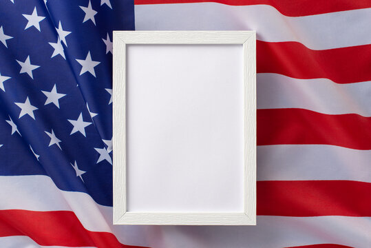American federal holiday concept. High angle view photo of empty rectangular wooden frame on american flag on isolated background with copy-space