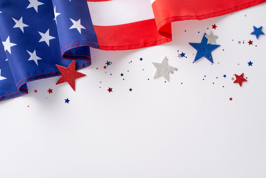 Labor Day in USA concept. Above view photo of empty space surrounded by white, blue and red star-shaped sparkles and american flag on white isolated background with copy-space