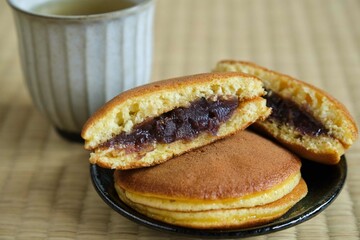 Japanese dorayaki and green tea on tatami.