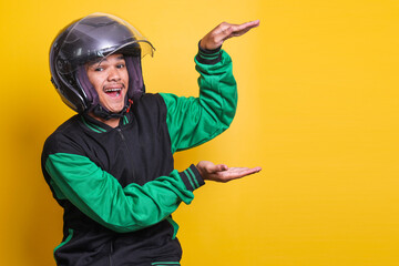 Asian online taxi driver wearing green jacket and helmet smiling with presenting gesture for advertisement