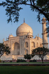 Fototapeta na wymiar Taj Mahal in morning light with the inscription of the coran in arabic letter meaning in english: This is an invitation to live on Earth as a good Muslim,