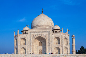 Fototapeta na wymiar Taj Mahal in India under blue sky with the inscription of the coran in arabic letter meaning in english: This is an invitation to live on Earth as a good Muslim