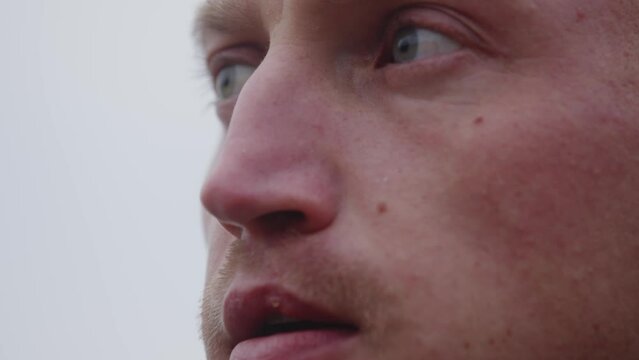 close up angle of a young man with determination in his eyes