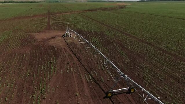 Farm machinery sprays herbicides on an agricultural field. Aerial view