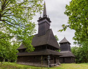 Fototapeta na wymiar Medieval Gothic wooden church, bell tower in Danylovo village , Ukraine