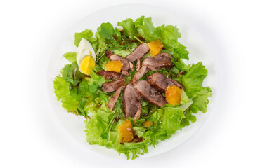 Salad of duck meat with different greens on white dish