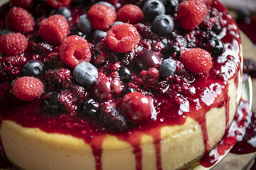 Closeup of a cheesecake covered with mixed berries
