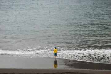 surfer walking on the beach