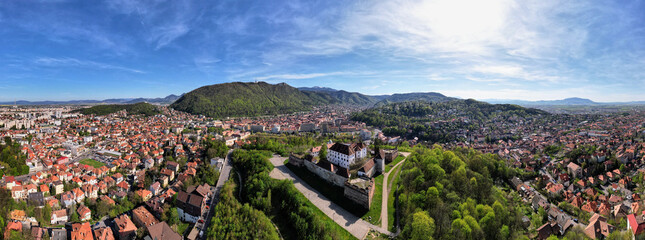 An extensive aerial panorama unveiling the historical Old Town in Brasov, Romania. Bathed in...