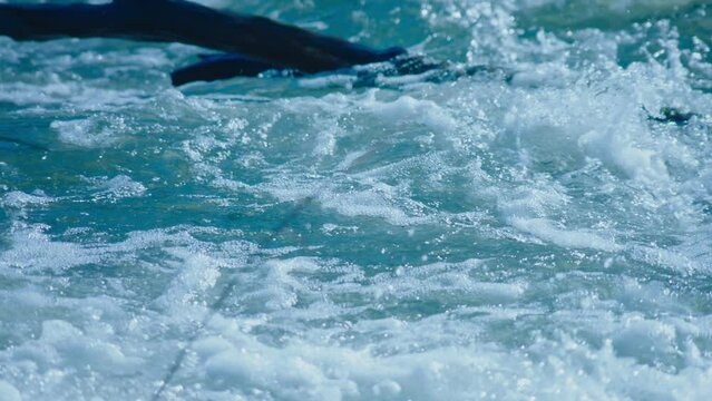 Slow Motion View Of Strong Current In River. Blue Water Sunlight And High Contrast.
