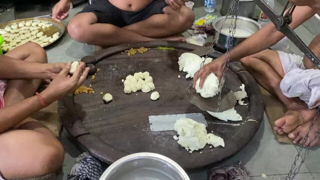 Staff preparing Bengali sweet in traditional style in an old shop in Kolkata.