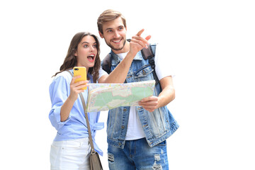 Beautiful young couple holding a map and smiling while standing on a transparent background. - obrazy, fototapety, plakaty
