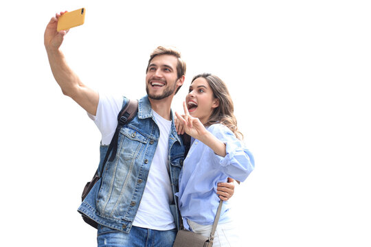 Beautiful lovely young couple walking at the city streets, hugging while taking a selfie on a transparent background.