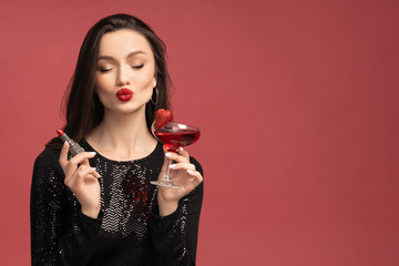 Beautiful girl with lipstick and cocktail in her hands