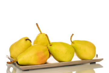 Several bright yellow pears on a metal tray, macro, isolated on white background.