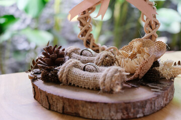 a rustic ring case or jewelry box made of wood and rattan. Wedding rings, wedding decoration and wedding concept