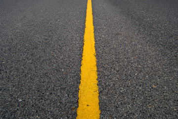 yellow line on asphalt or Texture road surface  have with yellow lines dividing traffic.