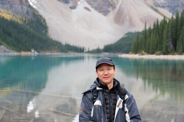 Tourist at Moraine Lake. Hiking Valley of Ten Peaks trail. Banff National Park, Alberta, Canada.