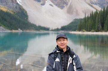 Fototapeta premium Tourist at Moraine Lake. Hiking Valley of Ten Peaks trail. Banff National Park, Alberta, Canada.