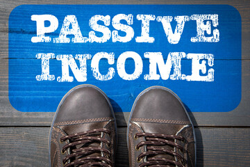 Passive Income Concept. Top View of Boot on wooden background