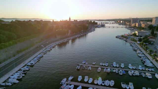 Landing a drone over Zadar town in Croatia at sunset. View over boats docked in marina Jazine